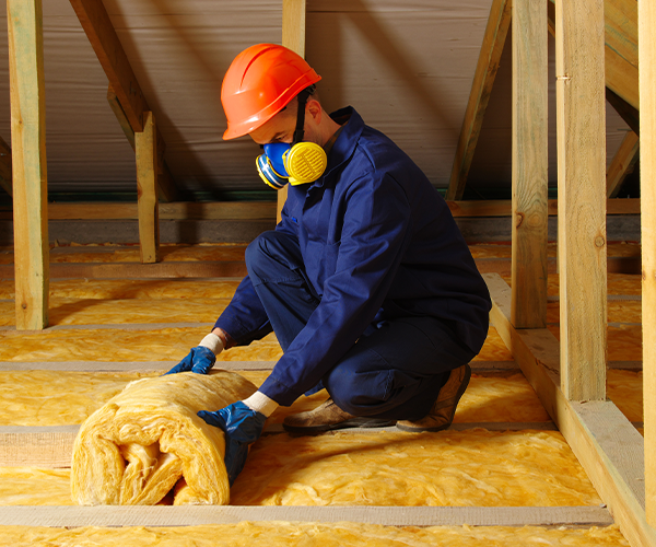 Worker rolling out insulation